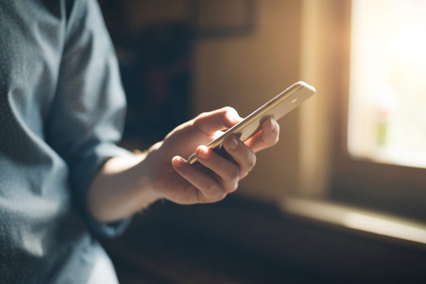 Hipster using a touch screen smart phone hands close up, vintage colors